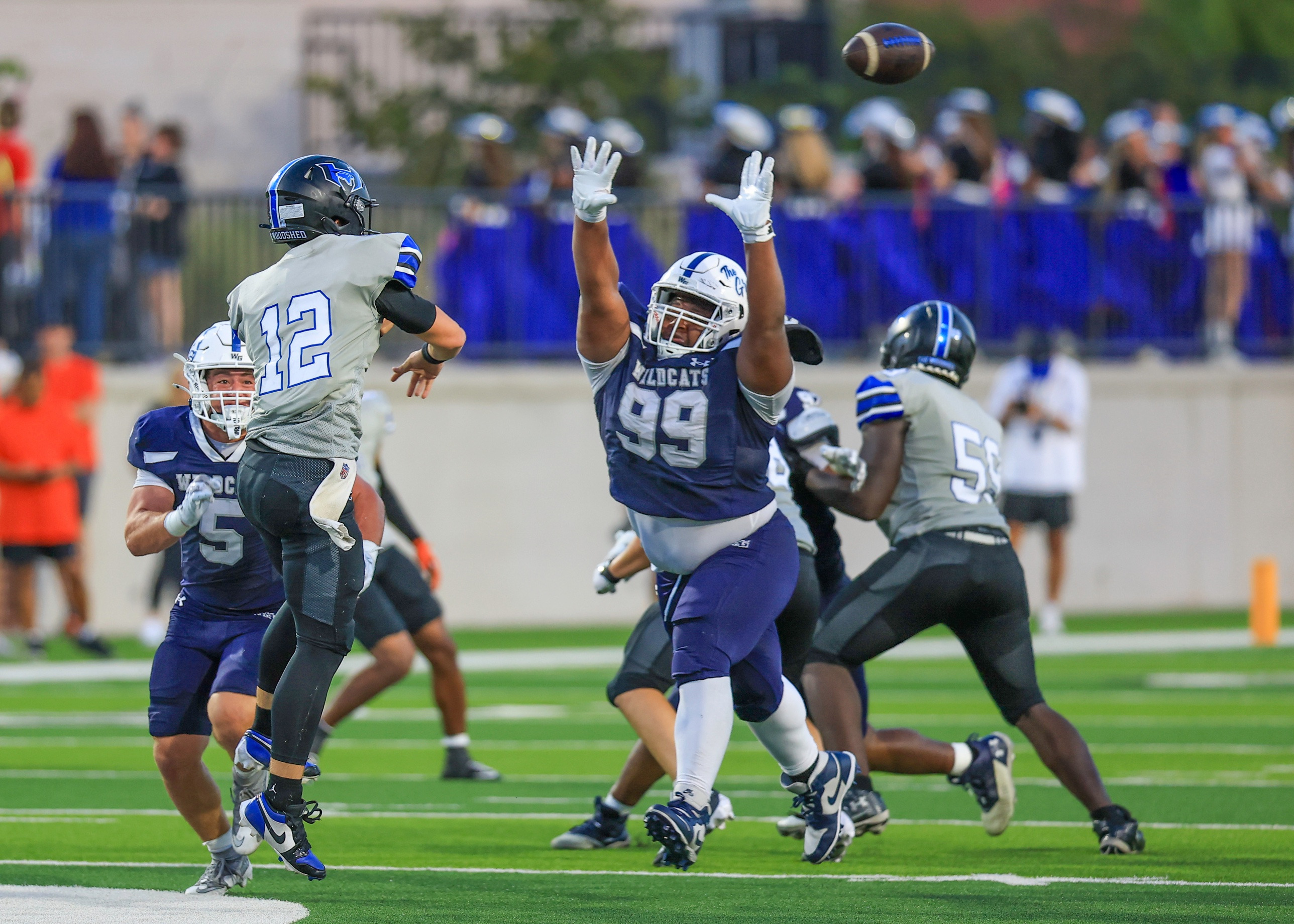 Kristopher Williams with both arms up, contesting a pass against Hebron